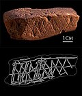 Ocher stone with linear engravings found at a workshop in Blombos Cave, South Africa. This stone dates to approximately 70,000 years ago.